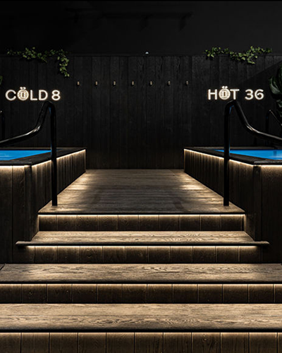 Illuminated steps leading to the hot and cold pools at Löyly Recovery